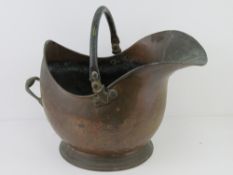 A large copper coal scuttle with swing handle over approx 45cm high.