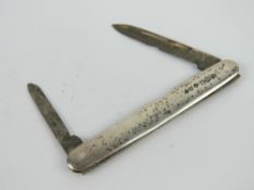 A HM silver double bladed fruit knife engraved for Dewars Scotch Whisky to one blade,