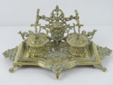 A pierced brass standish desk tray, liners deficient, 32cm wide.
