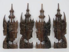 A set of four (2+2) opposing carved Tibetan deity figural heads,