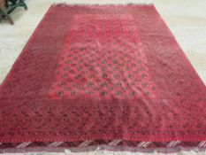 A red ground woollen rug having geometric pattern upon,