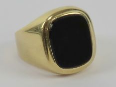 A 14ct gold signet ring set with unengraved onyx, stamped 585, size R, 6.5g.