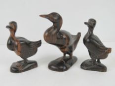 A family of three African rosewood ducks being mother standing 12cm high and young each standing