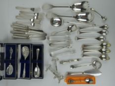 A quantity of assorted silver plated items inc knife rests, cake forks, butter knives, sugar tongs,