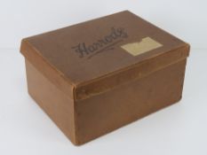 A vintage Harrods lidded cardboard box bearing 'Harrods of Knightsbridge' upon, 36 x 28 x 18cm.