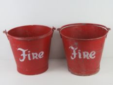 A pair of red painted galvanized steel 'fire' buckets, each with swing handle over, 33.5cm diameter.