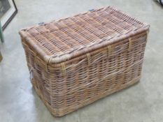 A wicker laundry hamper with twin end handles 75 x 47 x 46cm.