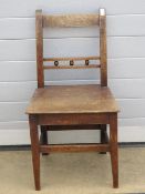 A single elm seated Oxford bar back chair.