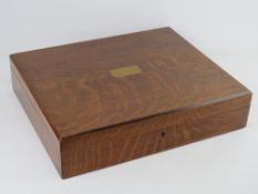 A good oak cutlery box with countersunk blank brass cartouche to the lid, contents deficient,