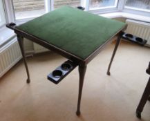 A patented folding leg games table having hinged bakelite guinea trays each with integral smokers