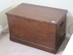 A late 19th century stained pine lidded trunk with end handles, 78 x 45 x 49cm.