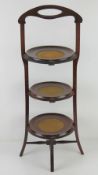 A mahogany three tier non hinged lazy susan cake rack,
