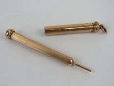 A gilded metal propelling pencil having chatelaine loop to top.