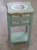 A delightful hand painted continental style two-drawer side table, legs united by under shelf,