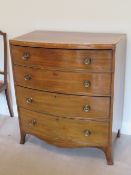 A good 19th century mahogany barrel fronted chest of four graduating drawers crossbanded with
