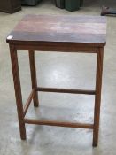 An oak side table raised over four reeded legs united by stretchers, 51 x 41 x 69.