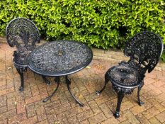 A cafe patio set comprising twin painted aluminium Victorian style chairs and matching circular
