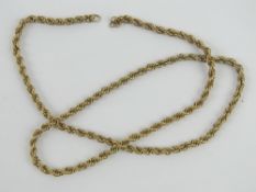 A yellow metal chain necklace, clasp deficient, no apparent hallmarks, untested, 49cm in length,
