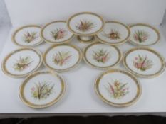 A delightful late Victorian eleven piece hand painted and gilded cabinet set comprising eight hand