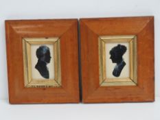 A pair of 19th century silhouettes heightened with chalk, each presented in birds-eye maple frames,