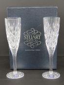 A pair of Stuart Crystal champagne flutes having original label on box.