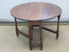 A Georgian country made gate leg drop leaf table in oak, 99 x 104cm.