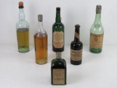 A quantity of six vintage liquor bottles with etiquettes (labels) including;
