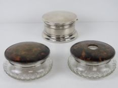 An HM silver dressing table powder pot having hinged lid opening to reveal vintage powder puff