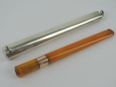 An amber 'dinner length' cheroot in HM silver case.