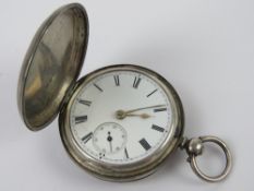An HM silver full hunter key wind pocket watch, hallmarked London 1877, glass deficient,