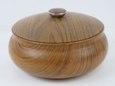 A delightful turned olive wood lidded bowl as made by Ianthe, 21cm wide.