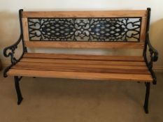A West Sussex Oak and cast metal framed garden bench, treated with Osmo oil and finished in beeswax,