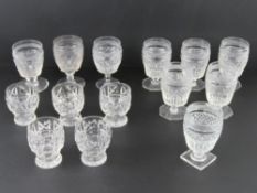A quantity of matched cut glass footed tumblers, some round base, some octagonal,