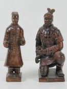 A pair of hand carved wooden samurai figurines, early 20th century, each 20cm high.