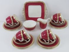 An eight piece George Jones tea service in gilded and mottled pink banding comprising eight trios