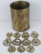 A brass waste paper bin having coaching scene upon, 26cm high.