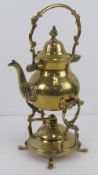 A brass teapot with spirit burner and stand all standing 31cm high.