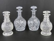 Two pairs of lidded cut glass decanters standing 24cm and 21cm high respectively.