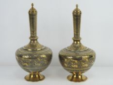 A good pair of decorative brass lidded baluster vases, 28cm high.