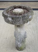 A two sectional stoneware bird bath.
