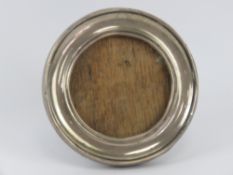 An HM silver circular photograph frame having wooden easel back, 9cm diameter,
