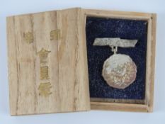 A WWII Japanese Mount Fuji medal in box.