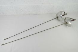 Two fencing foils having leather wrapped