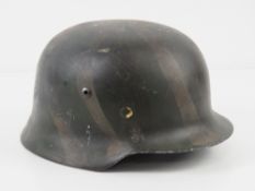 A reproduction WWII German M40 helmet wi