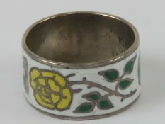 A sterling silver and enamel ring having blue, red and yellow roses upon, size N.
