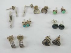 A white stone set silver pendant with matching earrings, stamped 925.