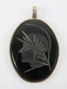 A large carved onyx pendant having warrior upon in HM silver frame, measuring 5.