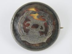 A WWI HM silver and tortoiseshell regimental sweetheart brooch having inlaid emblem for the