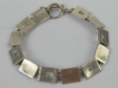 A silver bracelet having 1960s style geo