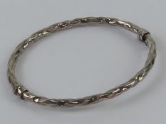 An hallmarked silver hinged bangle having safety clasp, internal dia 6 x 5.